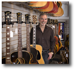 Gary Standing with Large Inventory of Vintage Guitars